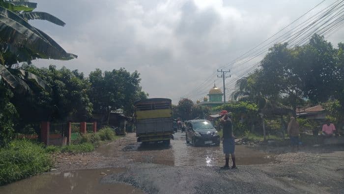 jalan_provinsi_siantarperdagangan_rusak_parah_pengendara_juga_keluhkan_pungli_di_simpang_kalvin