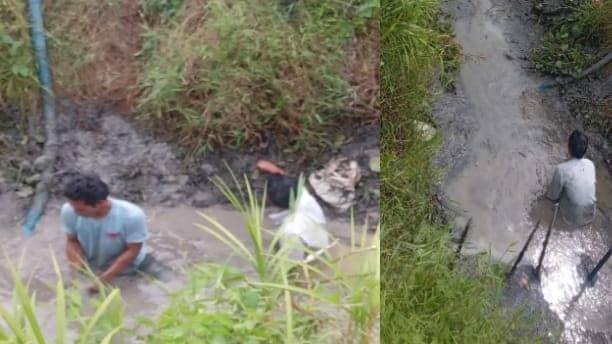 mencari_ikan_dengan_menguras_air_di_bekas_galian_undang_perhatian_pengguna_jalan