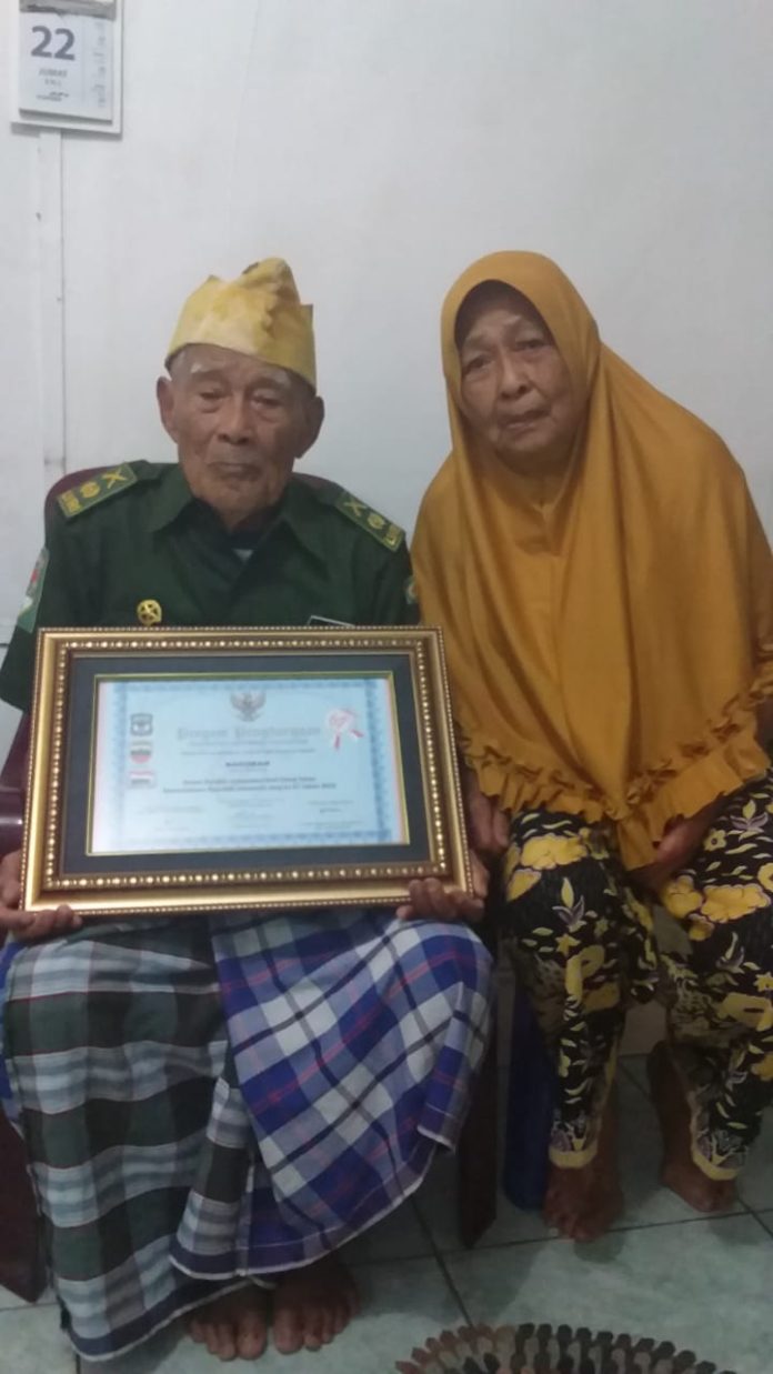 Sakiman, pejuang perang dunia ke II bersama istrinya, ditemui Mistar, Sabtu (23/11/19) di Jalan Mangga, Simalungun.(f:mistar/billy nasution)