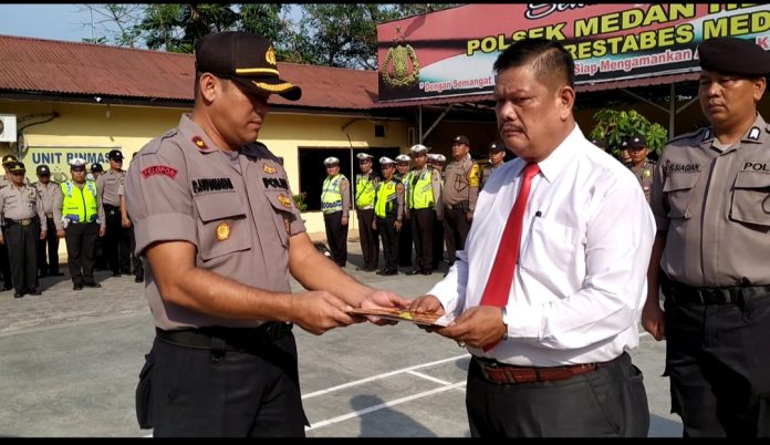 Kapolsek Medan Helvetia Kompol Pardamean Hutahaeansaat memberikan reward kepada personel berprestasi dan berdedikasi.(f:ist/mistar)