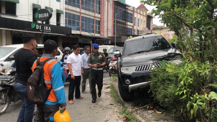 Mobil Pajero sport BK 1576 YX dikendarai mantan Ketua DPRD Simalungun 'manjat' trotoar dan nabrak pagar halaman rumah warga di Jalan Gereja, Kota Pematang Siantar, Rabu (5/4/23). (f: Hamzah/mistar.id).