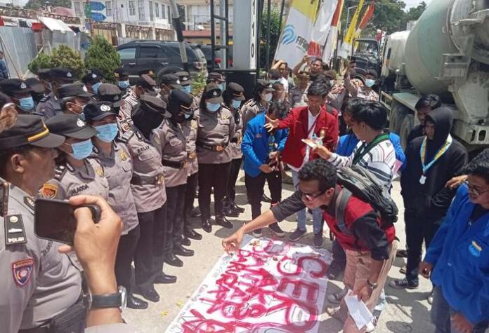 Aksi mahasiswa yang melakukan aksi tabur bunga di depan polisi (f:ferry/mistar)