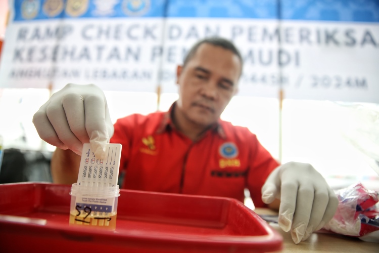 Petugas BNNP Sumut memeriksa urine milik sopir bus AKAP di Terminal Amplas Medan