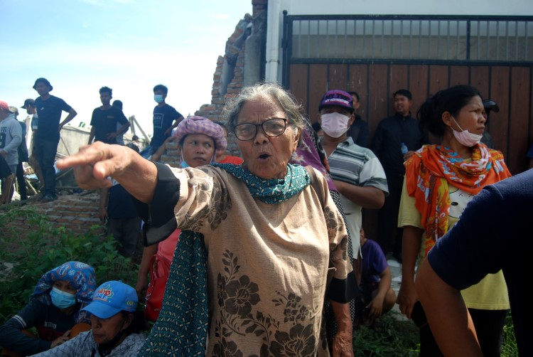 Seorang nenek melakukan protes saat bangunan miliknya dirobohkan oleh Satpol PP Deli Serdang di Desa Sampali