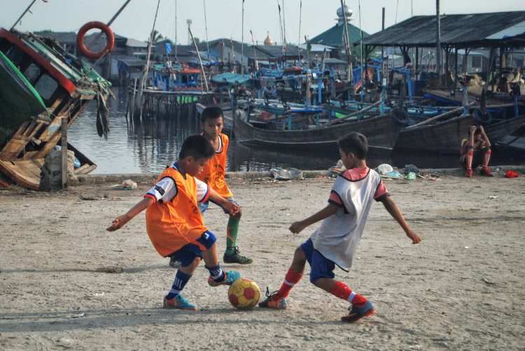 Sejumlah anak di Belawan bermain sepak bola di Lahan Gedung Serbaguna Gudang Arang