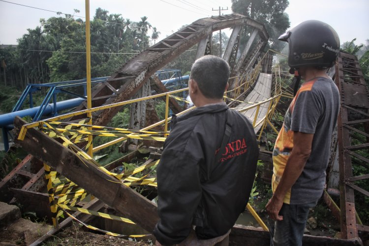 Warga melihat jembatan yang ambruk di Kelurahan Kampung Baru, Kota Medan