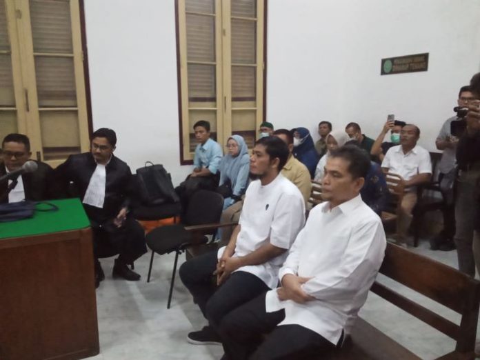 Alwi Mujahit Hasibuan (kanan) dan Robby Messa Nura (kiri) ketika bersiap menjalani sidang putusan.