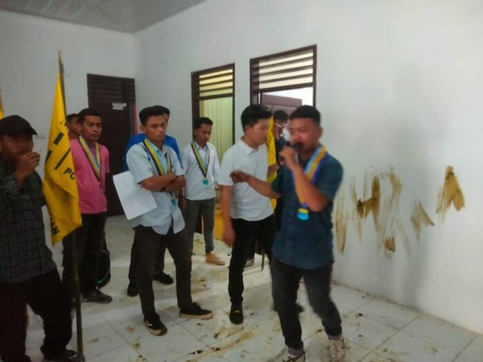 Mahasiswa bawa kotoran lembu ke kantor Dinas PMD Asahan saat gelar aksi demonstrasi. (Perdana)