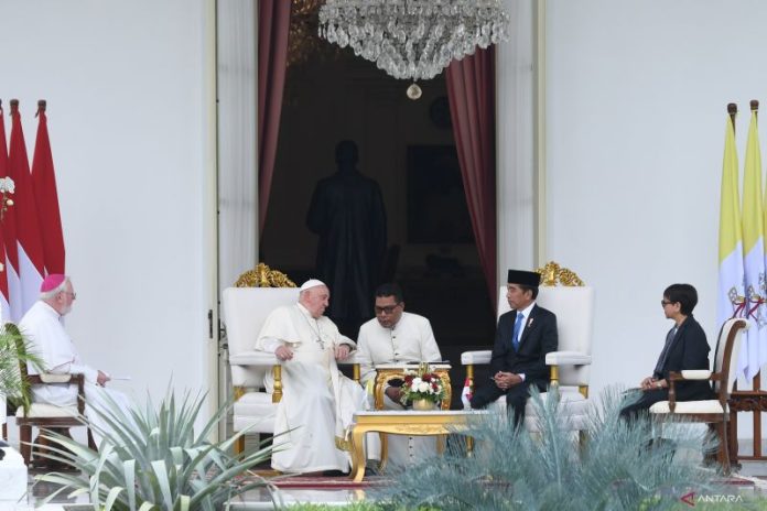 Presiden Indonesia Joko Widodo saat berbincang dengan Paus Fransiskus di beranda Istana Merdeka