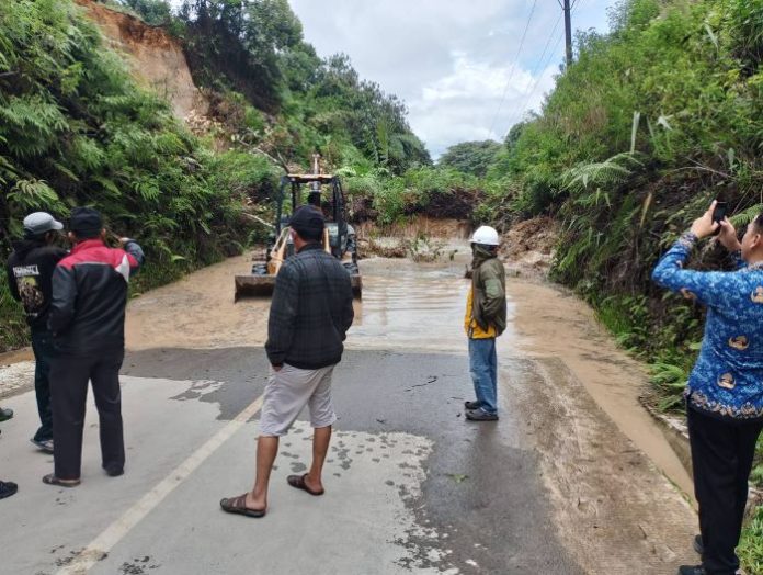 Alat berat PUTR sedang bekerja mengevakuasi material longsor di Sidikalang