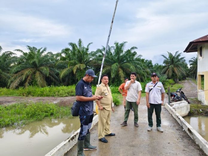 Camat Aek Kuo Rusdi Efendi (kedua kiri) bersama dengan personil BPBD dan BKSDA sebelum melakukan aktivitas di Dusun III Parit Minyak Desa Aek Korsik tempat munculnya buaya, Selasa (15/10/24).