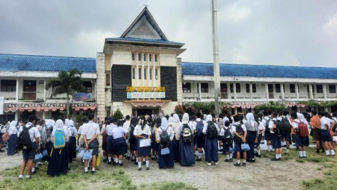 Para pelajar SMP N 1 Raya berbaris di halaman sekolah